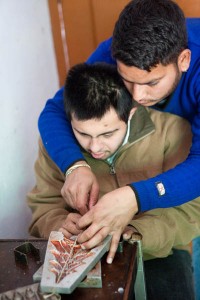 trainer and student working on a candle