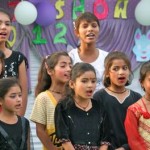 Children standing together, singing