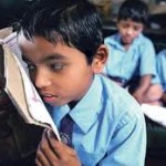 Visually impaired child in India School child with low vision holding a book right next to his eye