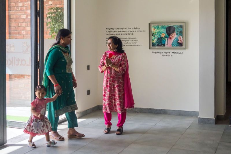 Open House visitors in the lobby beside the Moy Moy Chopra-McGowan (1989–2018) memorial photograph